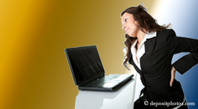 a person San Jose bending over a computer holding her back due to pain