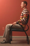 man sitting on chair looking left