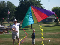 San Jose back pain free grandpa and grandson playing with a kite